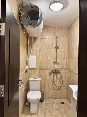 a bathroom with a shower and a toilet and a sink at Downtown Harmony Chill Place in Varna City