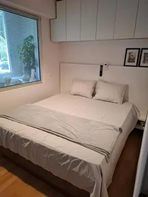 a large bed in a room with a window at Accommodation apartment MARGARITA in Burgas City