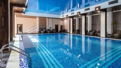 a swimming pool in a hotel with blue water at Garden of Eden K 518 in Sveti Vlas