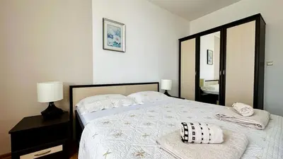 a bedroom with a bed with a pillow on it at Garden of Eden K 518 in Sveti Vlas