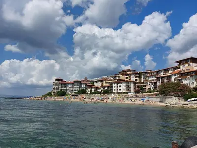 a beach with a group of people in the water at Garden of Eden K 518 in Sveti Vlas