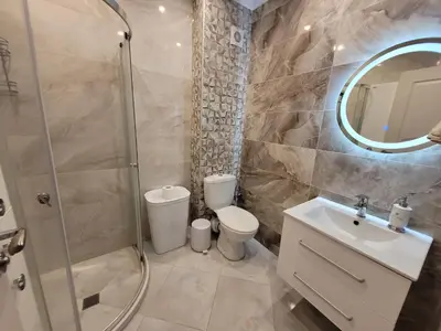 a bathroom with a shower and a toilet and a sink at Millenium II B34 in Sveti Vlas