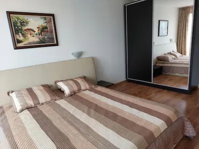 a bedroom with a bed and a large mirror at Royal Palm 170 in Sveti Vlas