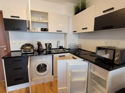 a kitchen with a washer and dryer on a counter at Royal Palm 170 in Sveti Vlas