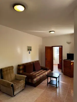 a living room with a couch and a coffee table at Benadi Guest House in Burgas City