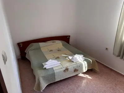 a small bed in a room with towels on it at Benadi Guest House in Burgas City