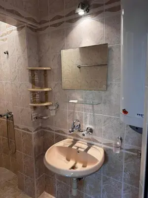 a bathroom with a sink and a shower at Benadi Guest House in Burgas City