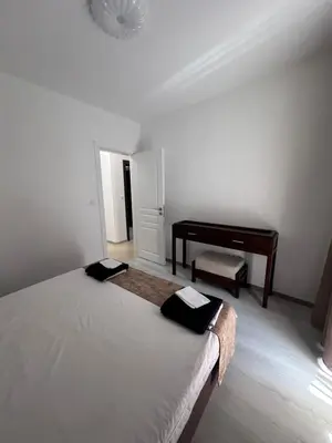 a white bedroom with a bed and a piano at Villa Tanita in Ravda