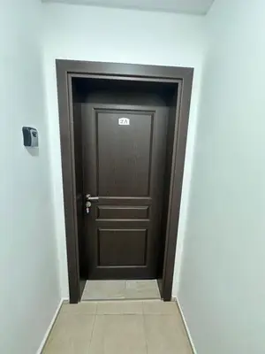 a brown door in a hallway with a tile floor at Villa Tanita in Ravda