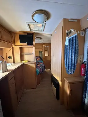 a small room with a kitchen and a bed at Каравана Бамбоо in Sozopol
