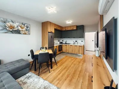 a living room with a couch and a table and a kitchen at Sea Horizon in Burgas City