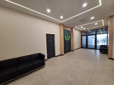 a waiting room with a couch and a door at Sea Horizon in Burgas City