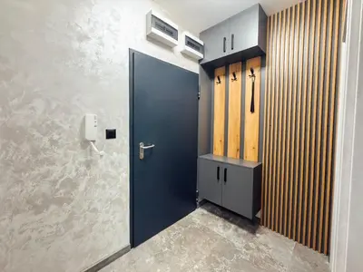 a blue door in a room with a wall at Sea Horizon in Burgas City