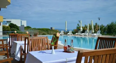 a restaurant with a table and a swimming pool at Appart complex - Egrek 6 in Lozenets