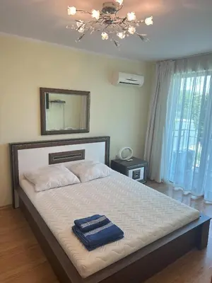 a bedroom with a bed with two blue towels on it at Appart complex - Egrek 6 in Lozenets