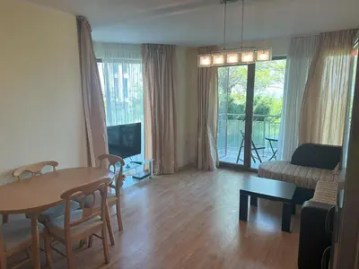 a living room with a table and a couch at Appart complex - Egrek 6 in Lozenets
