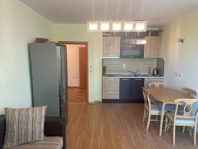 a kitchen and dining room with a table and chairs at Appart complex - Egrek 6 in Lozenets