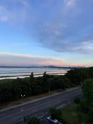 a road with cars parked on the side of the road at Sea View Escape in Burgas City