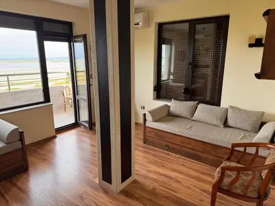 a living room with a couch and a view of the ocean at Sea View Escape in Burgas City