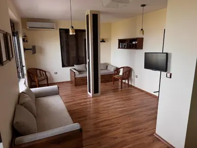 a living room with a couch and a tv at Sea View Escape in Burgas City
