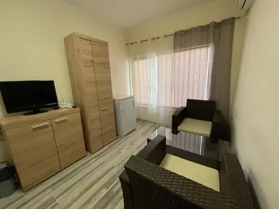 a small living room with a television and a couch at Mila 5 in Burgas City