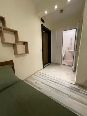 a bedroom with a bed and a bathroom at Mila 5 in Burgas City