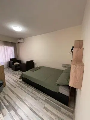 a bedroom with a bed and a living room at Mila 5 in Burgas City