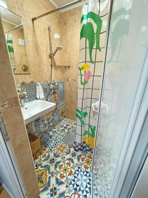 a bathroom with a shower and a sink at Blue Home in Burgas City