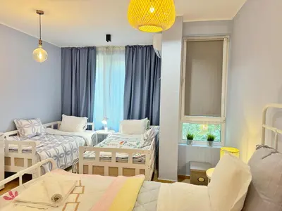 a small room with two beds and a window at Blue Home in Burgas City