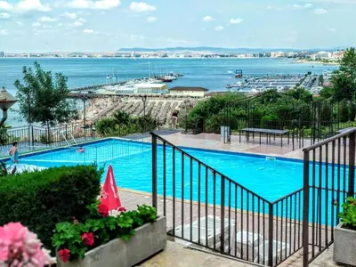 a swimming pool with a view of the water at Ela, Kedar 7 in Sveti Vlas