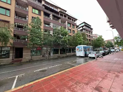 a city street with a bus parked in front of buildings at Laguna 3 минуты до моря in Pomorie