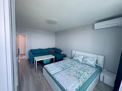 a small bedroom with a bed and a couch at Lazur Sea Home Burgas 2BD in Burgas City