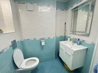 a bathroom with a toilet and a sink at Lazur Sea Home Burgas 2BD in Burgas City
