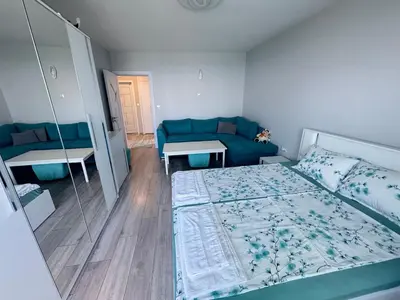 a small bedroom with a bed and a couch at Lazur Sea Home Burgas 2BD in Burgas City