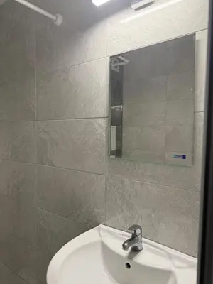 a bathroom with a sink and a mirror at Sea Side in Burgas City