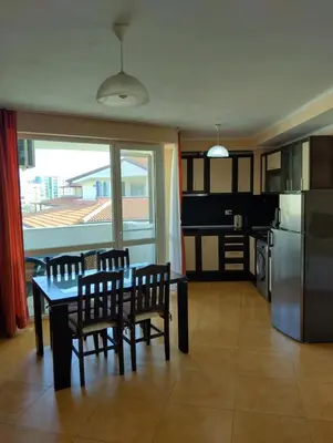 a kitchen and dining room with a table and chairs at Отдых in Sunny Beach