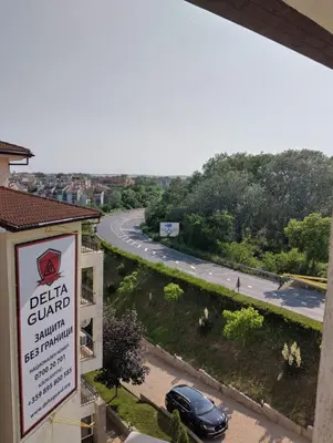 a sign for a dealer with a car on a road at Отдых in Sunny Beach