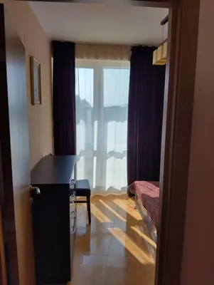 a room with a desk and a bed and a window at Отдых in Sunny Beach