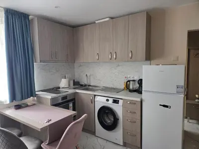 a kitchen with a white refrigerator and a washing machine at Апартамент 9 -Рилска in Burgas City