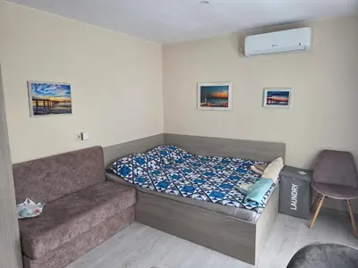 a small bedroom with a bed and a couch at Апартамент 9 -Рилска in Burgas City