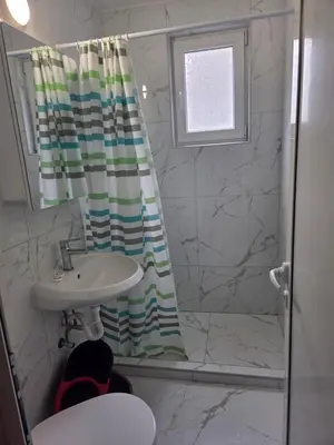 a bathroom with a sink and a shower curtain at Апартамент 9 -Рилска in Burgas City