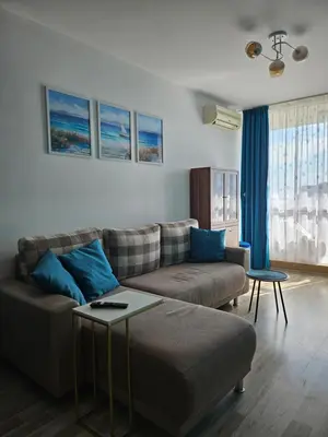 a living room with a couch and a table at 2BR Sea Sunrise View Apartment Happy Place in Chernomorets