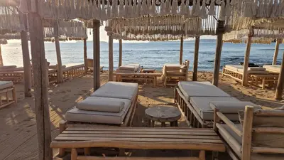 a beach with chairs and umbrellas and the ocean at 2BR Sea Sunrise View Apartment Happy Place in Chernomorets