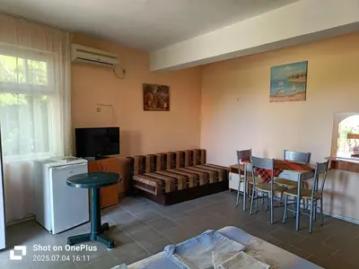 a living room with a couch and a table at Вила Фернандес in Chernomorets