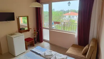 a living room with a view of a balcony at Вила Фернандес in Chernomorets