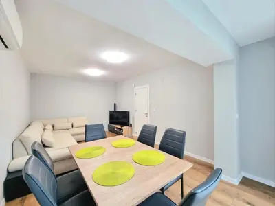 a dining room with a table and a couch at Relax & Spa-House near Therma Numera in Burgas City