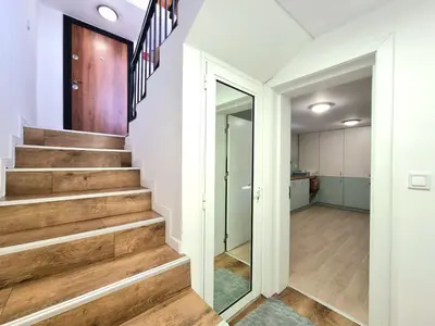 a hallway with wooden stairs in a house at Relax & Spa-House near Therma Numera in Burgas City