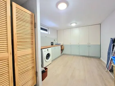 a laundry room with white cabinets and a washer and dryer at Relax & Spa-House near Therma Numera in Burgas City