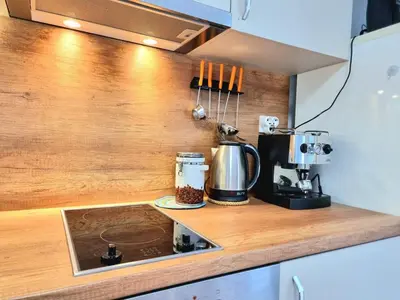 a kitchen counter with a coffee maker on a counter top at Relax & Spa-House near Therma Numera in Burgas City