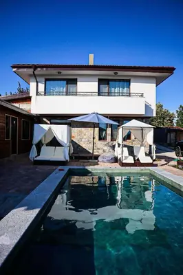 a house with a swimming pool in front of a house at Конакъ Войнов in Yasna Polyana